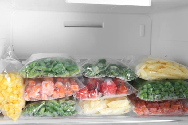 istock Plastic bags with different frozen vegetables in refrigerator 1334790826