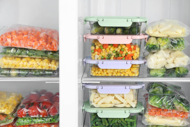 istock Plastic bags and containers with different frozen vegetables in refrigerator 1334791854