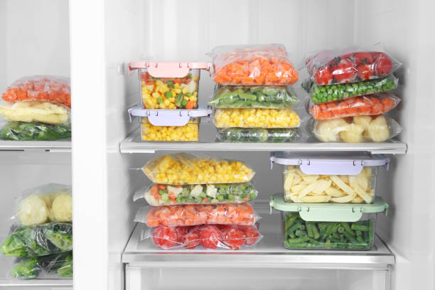 istock Plastic bags and containers with different frozen vegetables in refrigerator 1334791878