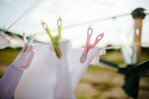 Laundry dries with plastic clothespin in spring breeze