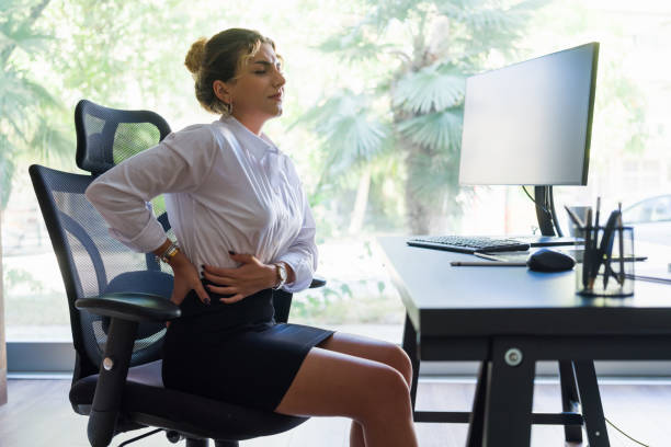 istock Businesswoman Having Spine Ache Due To Work Overload And Bad Posture 1334797959