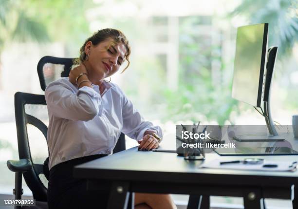 Businesswoman Having Neck Ache Due To Work Over Load And Bad Posture Stock Photo - Download Image Now