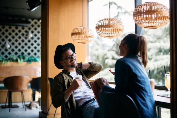 istock Young happy students having fun while drinking coffee and talking in a cafe. 1334801472