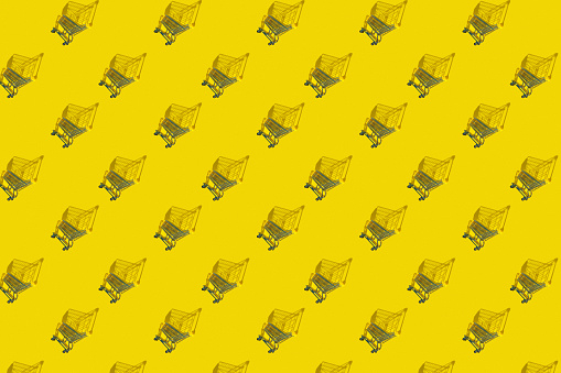 Shopping cart on a yellow background. Minimal style. Sale. Shopping concept pattern, shopaholism