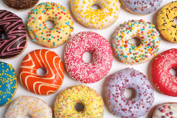 istock Delicious glazed donuts on white background, flat lay 1334802869
