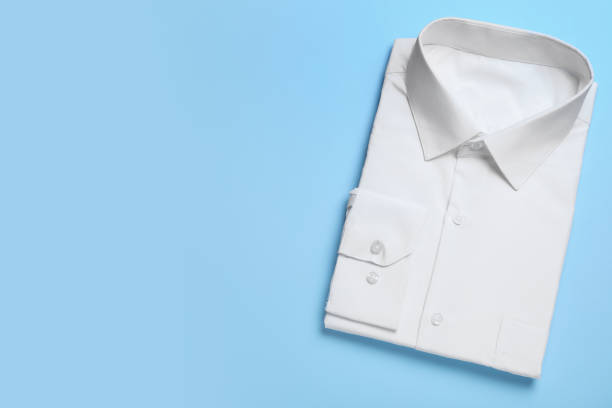 istock Stylish white shirt on light blue background, top view with space for text. Dry-cleaning service 1334802970