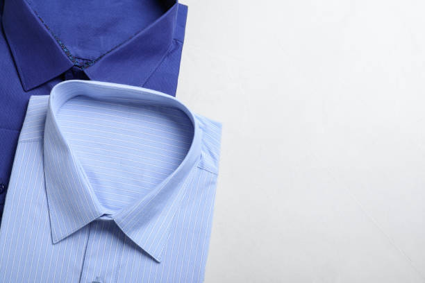 istock Stylish shirts on light table, flat lay with space for text. Dry-cleaning service 1334802992