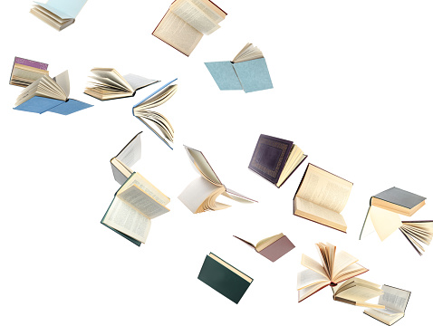Old hardcover books flying on white background