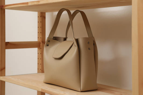 istock Stylish woman's bag on shelf in boutique 1334803020