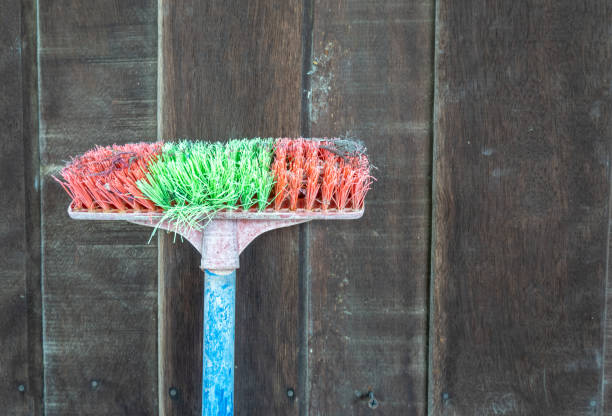 istock Old floor brush, placed on a wooden plank 1334803152