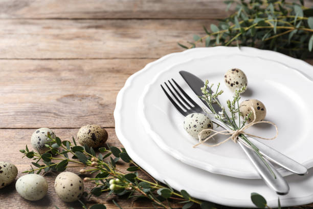 istock Festive Easter table setting with quail eggs and floral decor on wooden background, closeup 1334803873