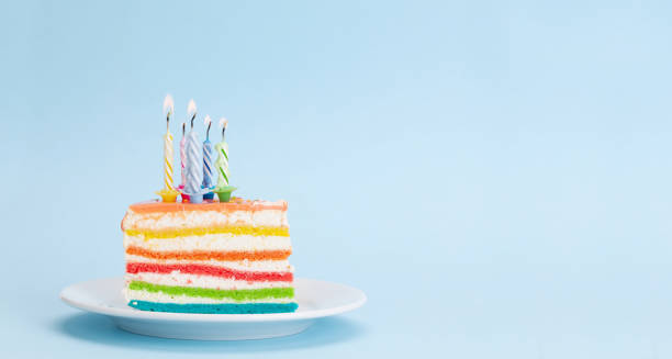 istock Birthday or holiday cake with burning candles on a blue 1334803911