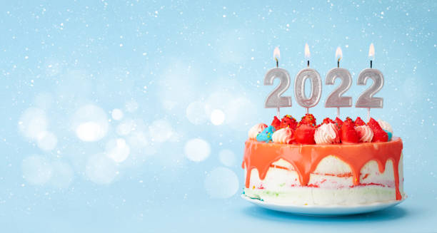 istock Christmas cake with number 2022 burning candles 1334803986