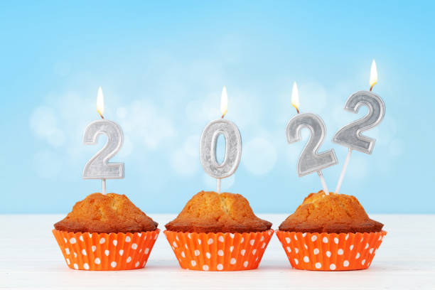 istock Christmas card with cupcakes, and 2022 candles 1334805167