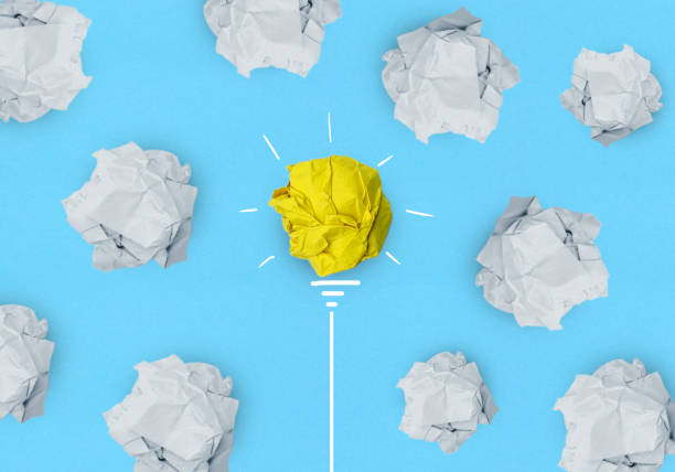 istock Creative idea, Inspiration, New idea, solution and Innovation concept with Crumpled yellow paper light bulb on blue background 1334805188