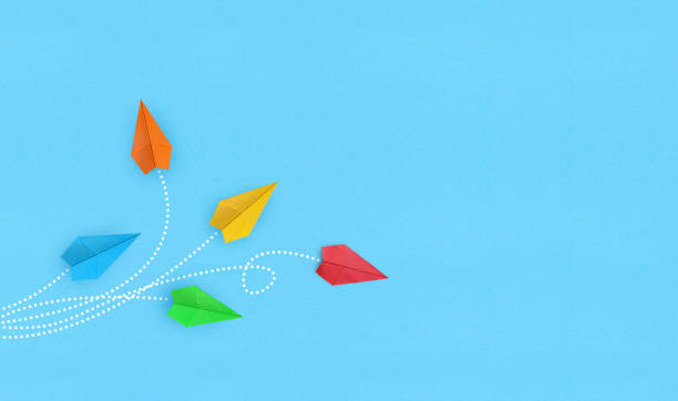 istock Color paper airplanes on white background 1334805495