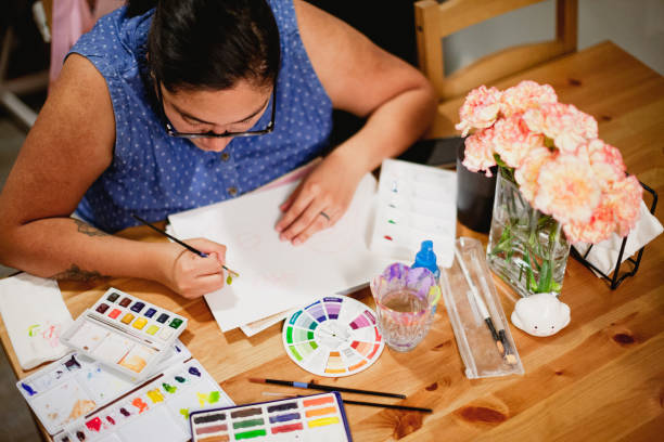 istock Hispanic Woman Painting and making art 1334805624
