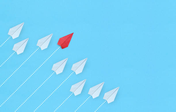 istock Leadership concept with red paper plane leading among white on blue background with copy space 2 1334807404