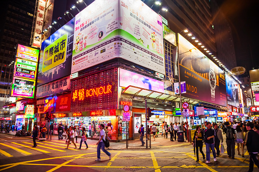 HONG KONG - MARCH 19, 2013: Signboards with neon light advertisement on Mongkok pedestrian shopping street in Hong Kong.