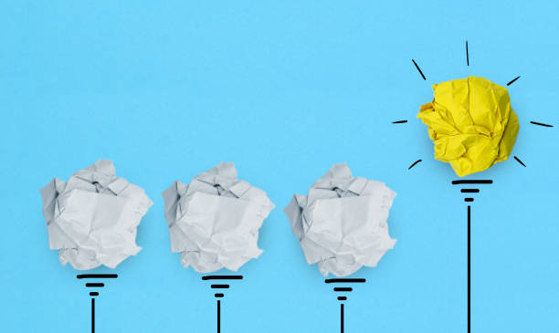 istock Creative idea, Inspiration, New idea and Innovation concept with Crumpled Paper light bulb on blue background 1334807940