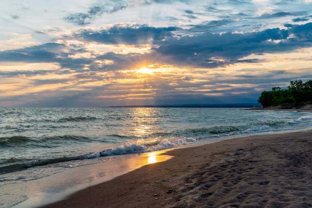 Lake Erie beach sunrise Lake Erie beach sunrise at Presque Isle State Park lake erie stock pictures, royalty-free photos & images