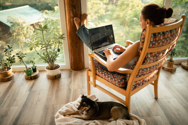 istock Woman sitting on her terrace and using laptop for work 1334812508