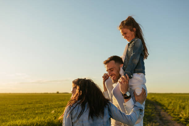 istock Happy family walking in the fields 1334814408