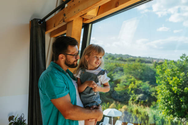 istock Beautiful family looking through window 1334815609