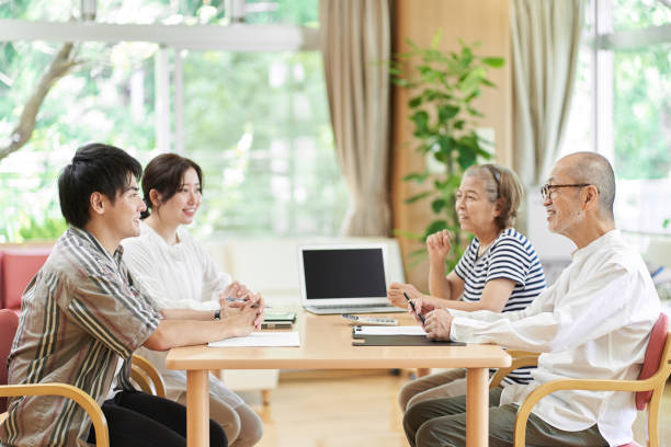 istock Young couple and old couple talking with a smile 1334815683