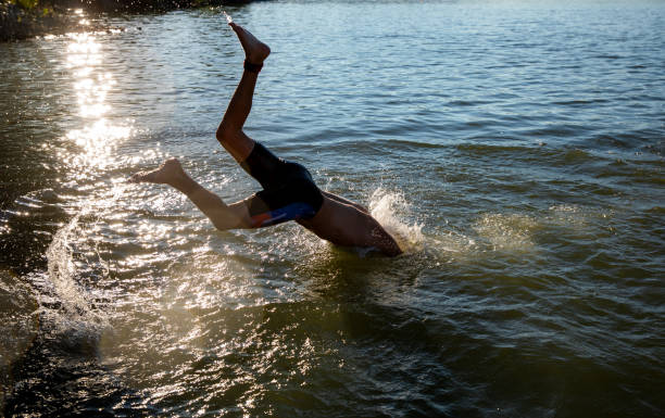 istock Swimmer jumping into water during marathon swimming competition 1334816114