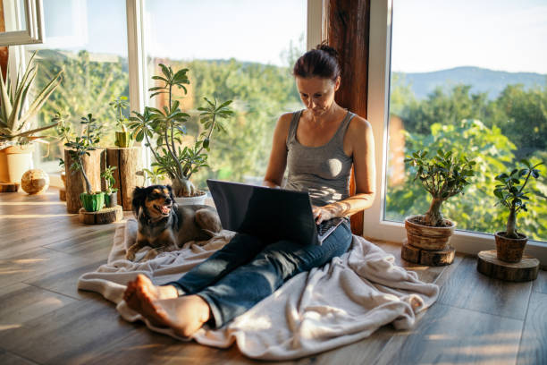 istock Woman sitting on her terrace and using laptop for work 1334816678