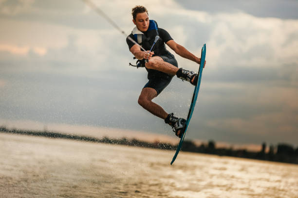 istock Surfer jumping at the sunset 1334817486