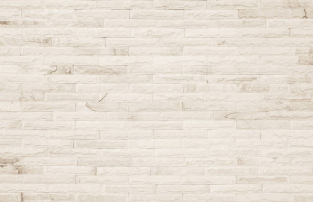 istock Empty Background of wide cream brick wall texture. Old brown brick wall concrete or stone pattern nature, wallpaper limestone abstract floor/Grid uneven interior rock. Home & office design backdrop. 1334819105