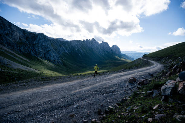 istock Woman ultramarathon runner running at mountain top 1334820275