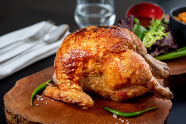 istock Roasted whole chicken cooked on charcoal with bulgur pilaf on wooden board. 1334820893