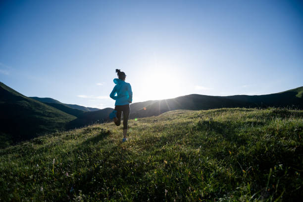 istock Young woman runner running at mountain top 1334822959