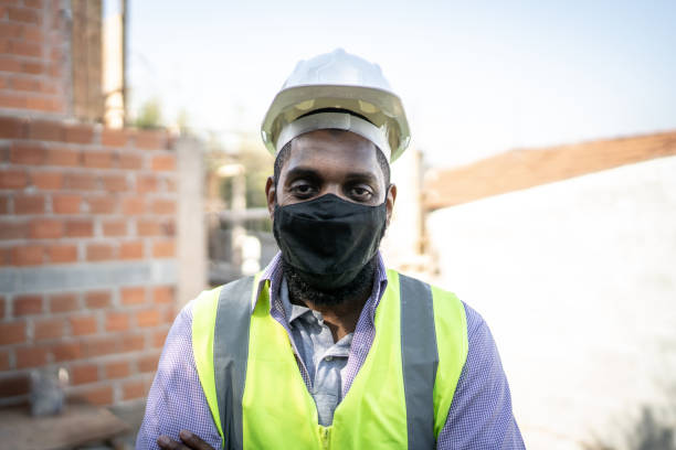istock Portrait of a construction worker using protective face mask in construction site 1334823055