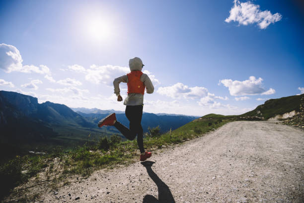istock Woman trail runner running on mountain top 1334823341