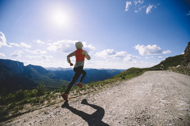 istock Woman trail runner running on mountain top 1334823364