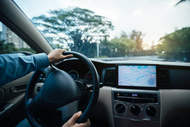 istock People hands driving car in modern city 1334823586