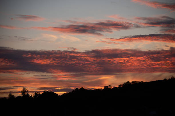 istock Red clouds lit up by the sun at sunset.. 1334825412