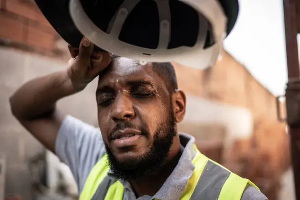 Photo of Exhausted construction worker at construction site