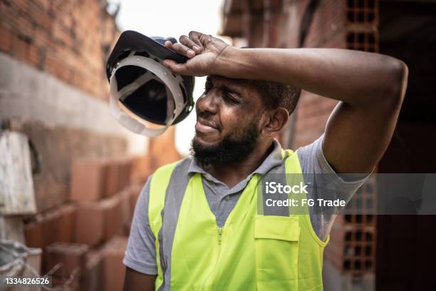 Exhausted Construction Worker At Construction Site Stock Photo - Download Image Now - Heat - Temperature, Working, Construction Worker