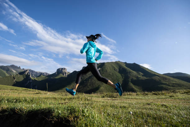istock Young woman runner running at mountain top 1334829452