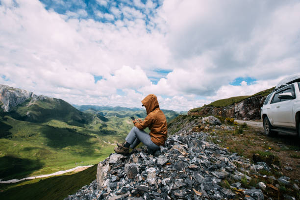 istock Successful woman hiker using smart phone on alpine mountain top 1334829589