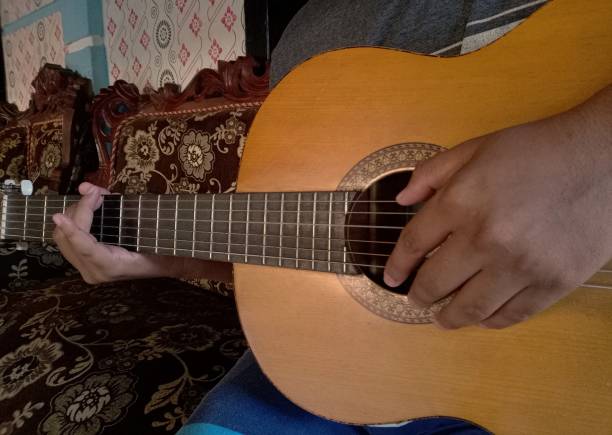 istock a young man playing the guitar 1334829850