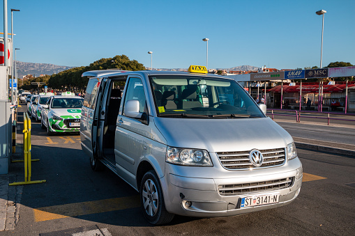 Taxi in Split, Croatia with people and business names visible in the background