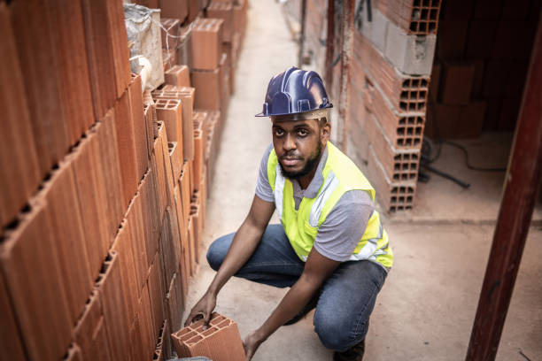 istock Portrait of a construction worker building a brick wall 1334830889