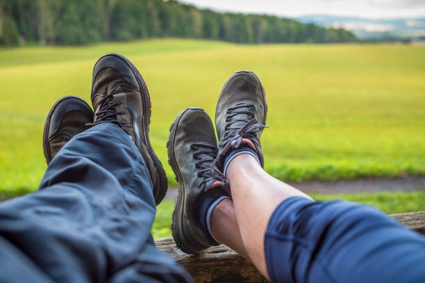 Saxon Switzerland, Saxony, Germany - August 11, 2021: Hiking in nature in Saxon Switzerland in the Elbe Sandstone Mountains. Walking shoes of a man and a woman.