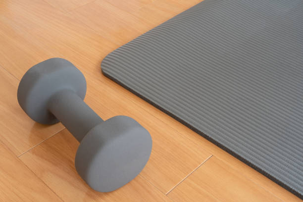 istock A dumbbell and a yoga mat on the floor. 1334832059